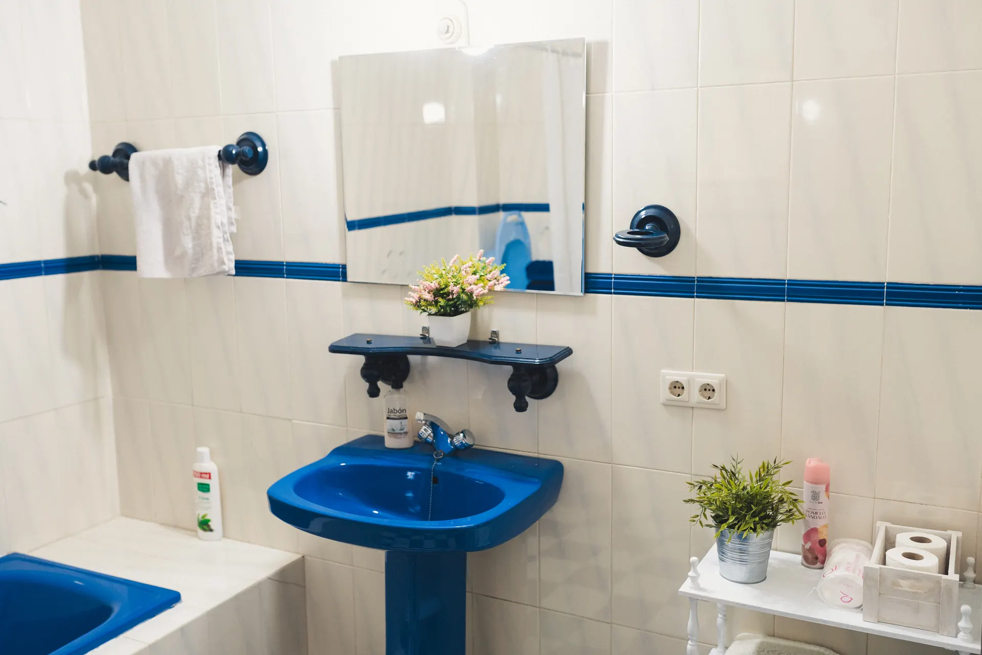 Baño en azul y blanco con lavabo de pedestal y bañera